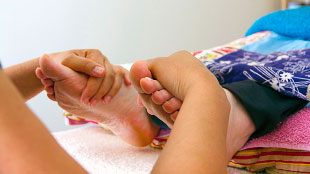 Image of therapist massaging client's feet